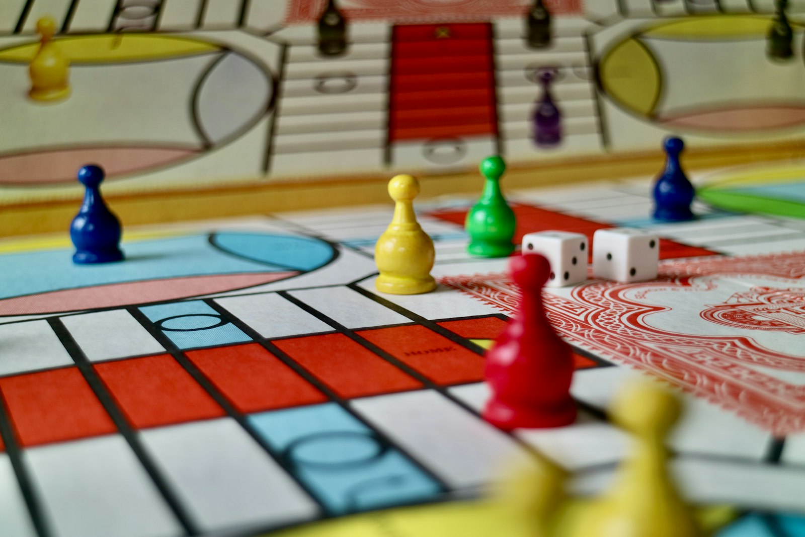 Board game pieces and dice arranged for a strategy prediction round